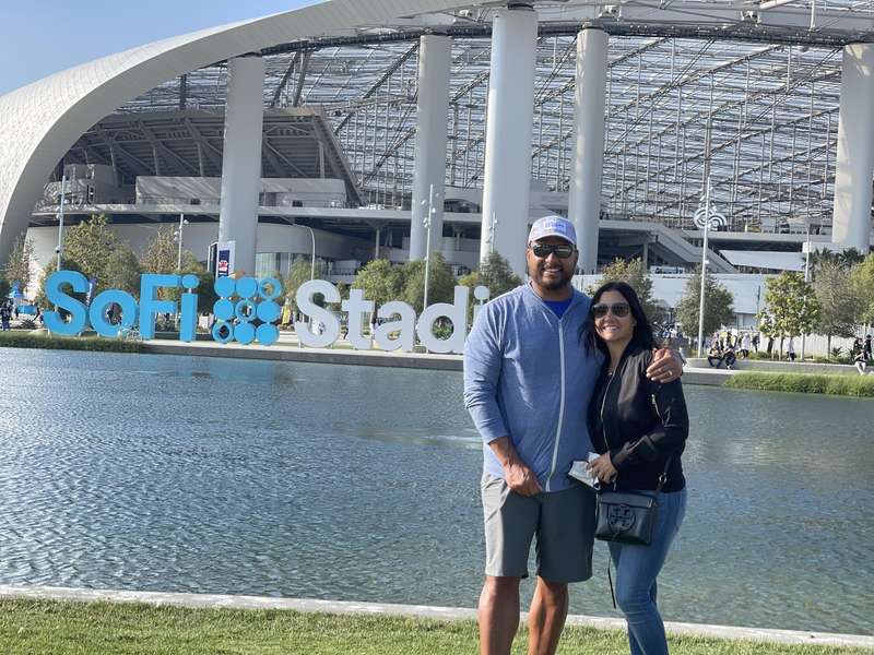 Gary and partner at SoFi Stadium sign