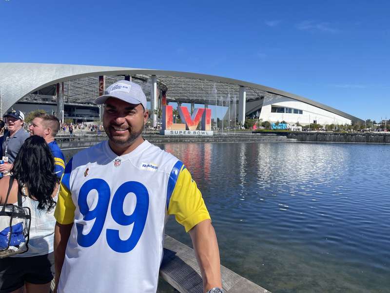 Fan posing with Super Bowl backdrop